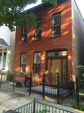 view of front facade with a fenced front yard and brick siding