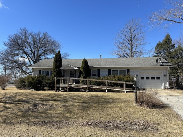 ranch-style home featuring driveway, a deck, and an attached garage