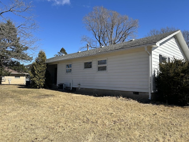 back of house featuring a yard, central AC unit, crawl space, and a shingled roof