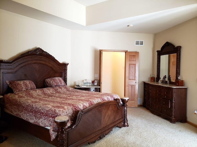 bedroom with baseboards, visible vents, and light carpet