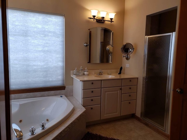 full bathroom featuring vanity, plenty of natural light, a whirlpool tub, a shower stall, and tile patterned floors