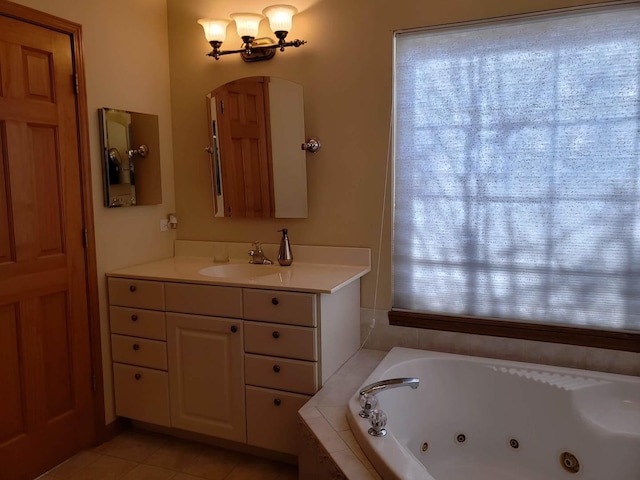 full bath featuring tile patterned flooring, vanity, and a tub with jets