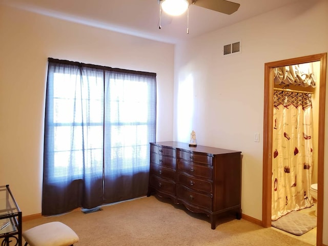 sitting room featuring visible vents, baseboards, light colored carpet, and a ceiling fan