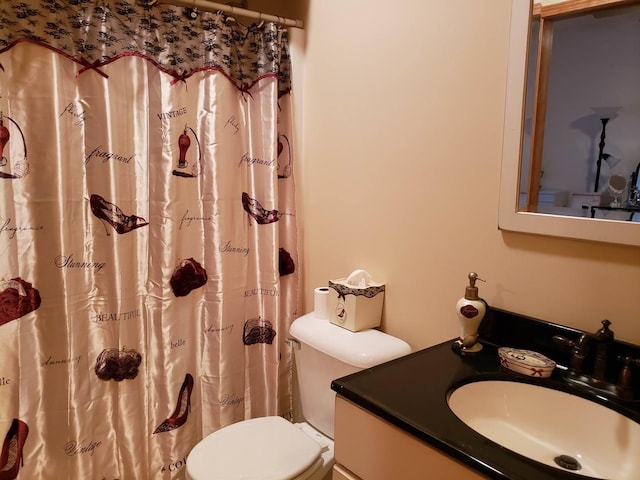 bathroom featuring vanity, curtained shower, and toilet