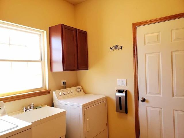 laundry room with washer and dryer, cabinet space, and a sink