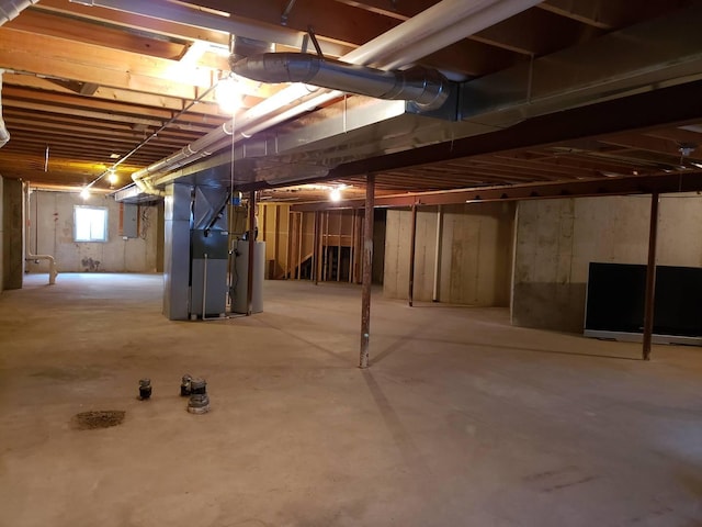 basement featuring gas water heater and heating unit