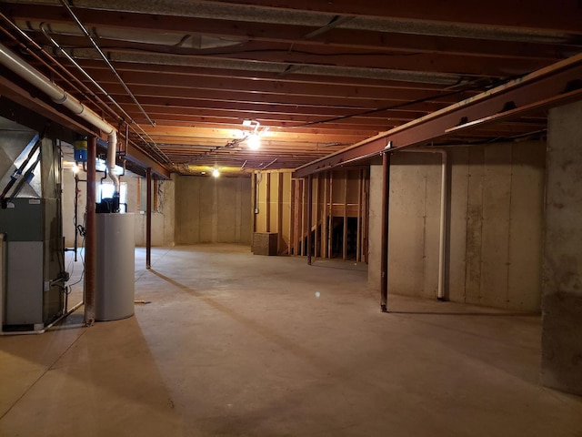 unfinished basement with gas water heater and heating unit