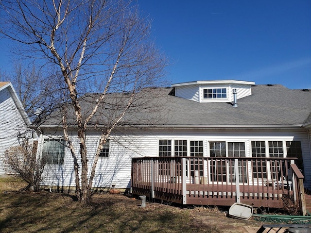 back of property featuring a deck and roof with shingles