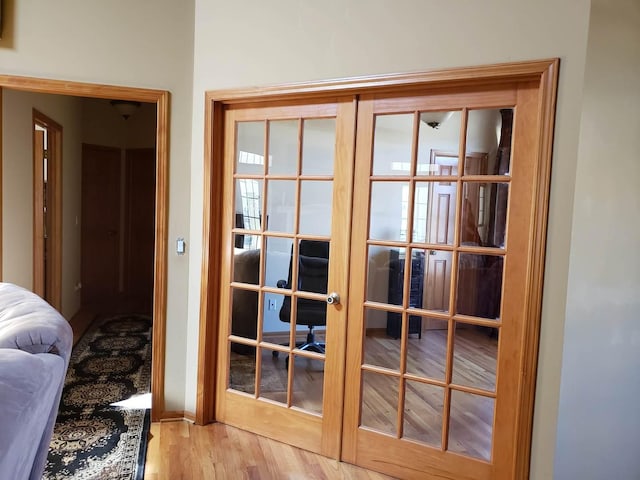 doorway with wood finished floors and french doors