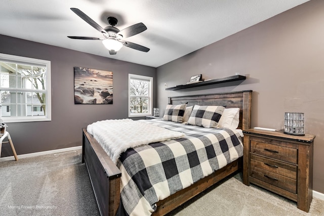 carpeted bedroom featuring a ceiling fan and baseboards