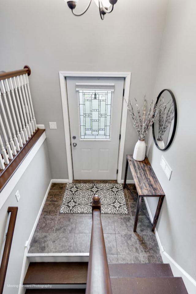 tiled foyer entrance with stairway and baseboards