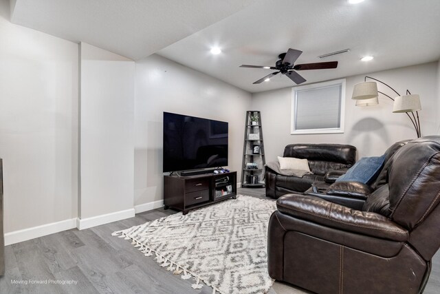 living area featuring recessed lighting, wood finished floors, visible vents, a ceiling fan, and baseboards