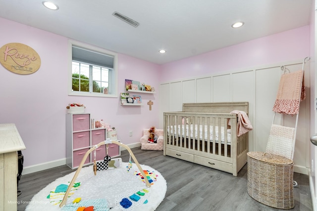 bedroom featuring recessed lighting, visible vents, and wood finished floors