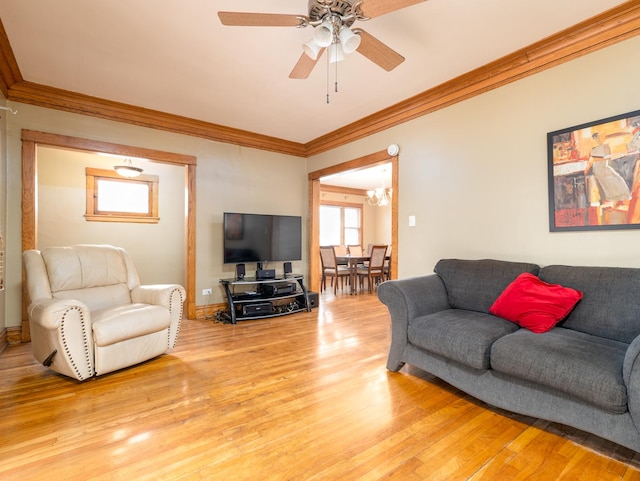 living room featuring ceiling fan, light wood finished floors, and ornamental molding