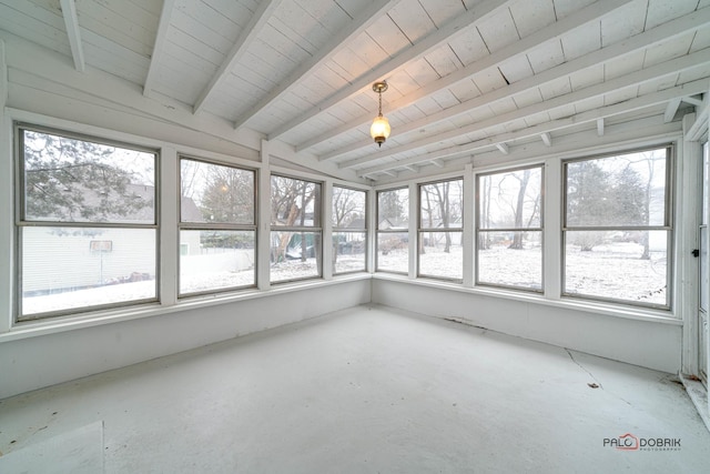 unfurnished sunroom featuring beam ceiling