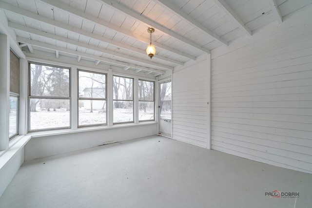 unfurnished sunroom featuring beam ceiling