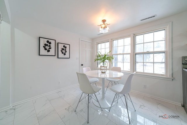 dining space featuring marble finish floor, visible vents, plenty of natural light, and baseboards