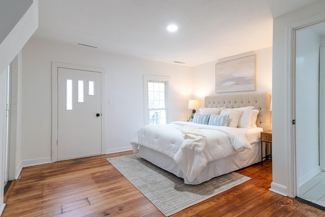 bedroom featuring wood-type flooring and baseboards