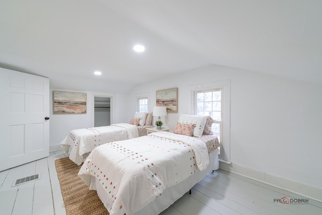 bedroom with vaulted ceiling, recessed lighting, visible vents, and baseboards