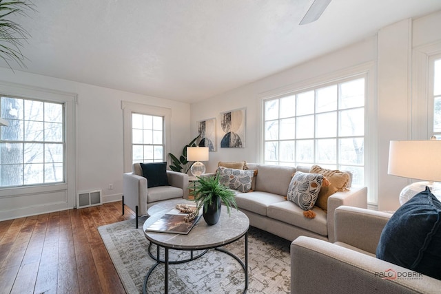 living room featuring visible vents and hardwood / wood-style flooring