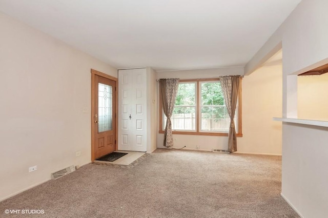 unfurnished room featuring carpet and visible vents