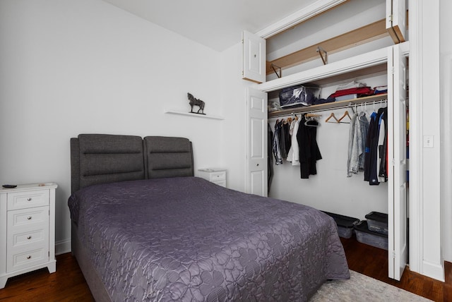 bedroom with dark wood-style floors and a closet