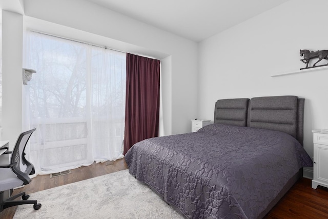 bedroom with wood finished floors and visible vents