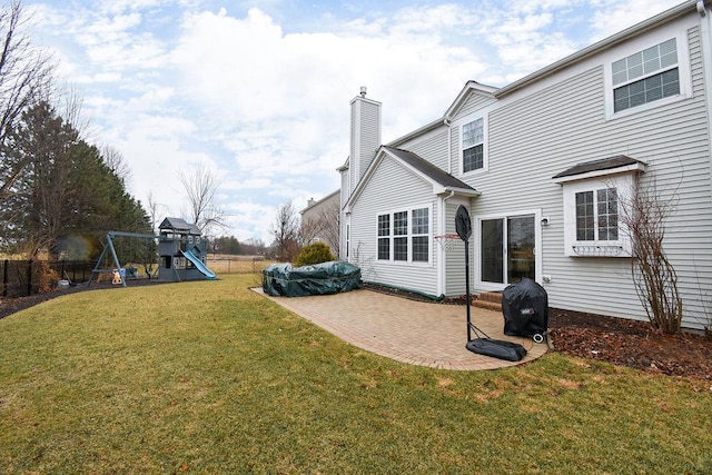 view of yard with fence, a playground, and a patio