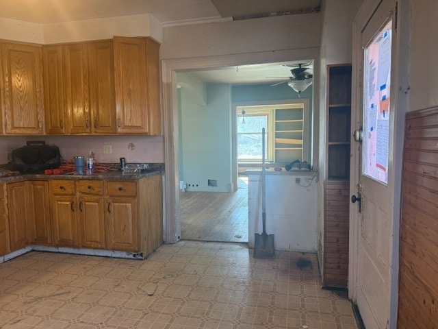 kitchen with brown cabinets, ceiling fan, and light floors