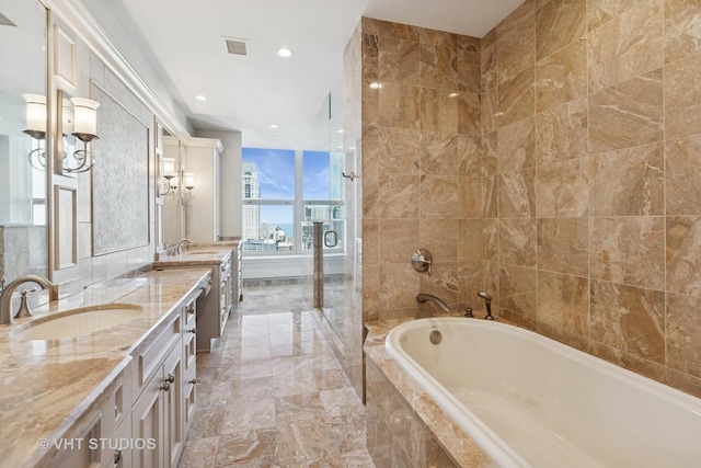 bathroom featuring double vanity, a garden tub, visible vents, and a sink