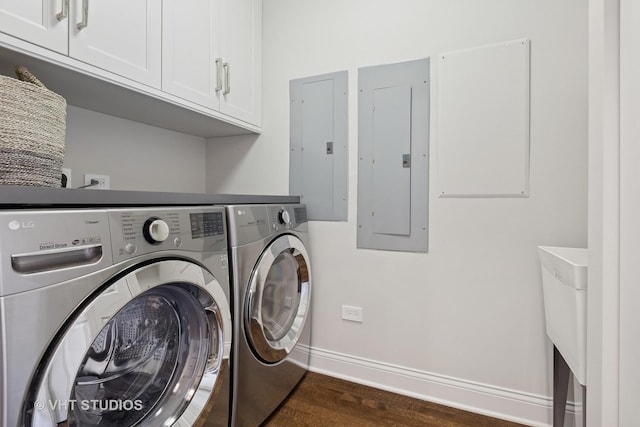 washroom featuring electric panel, cabinet space, and washing machine and clothes dryer