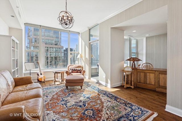 living area featuring a view of city, a notable chandelier, wood finished floors, and baseboards