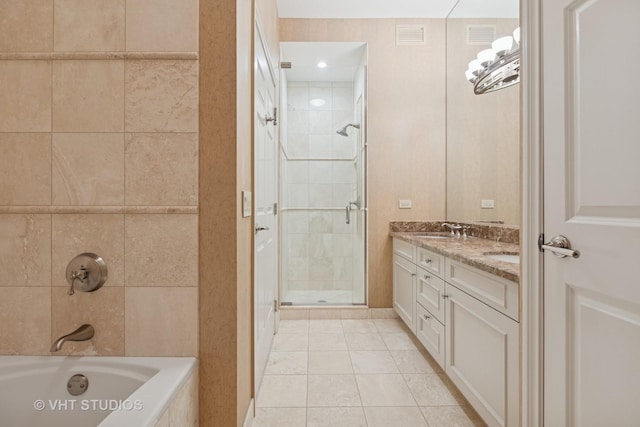 bathroom with double vanity, visible vents, tile patterned floors, and a sink