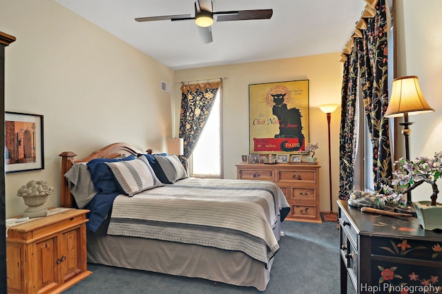 carpeted bedroom featuring visible vents and a ceiling fan