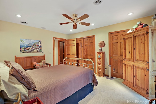 bedroom with recessed lighting, visible vents, light colored carpet, and ceiling fan