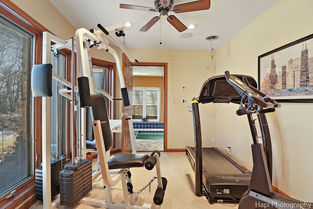 workout area featuring visible vents, a ceiling fan, baseboards, and carpet floors