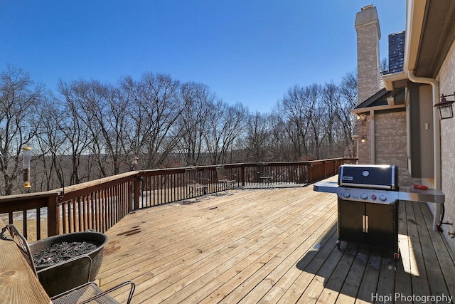 wooden terrace featuring grilling area