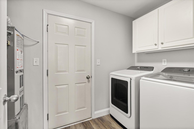 clothes washing area with baseboards, cabinet space, dark wood-type flooring, and washer and clothes dryer