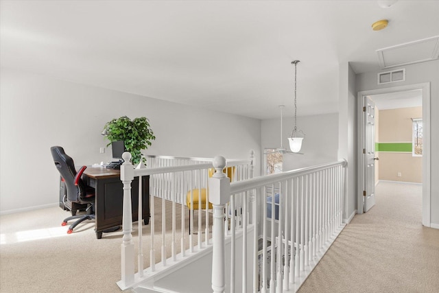 hallway featuring an upstairs landing, visible vents, baseboards, and carpet