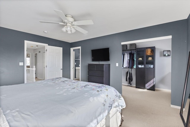 bedroom featuring a ceiling fan, baseboards, a closet, and light carpet