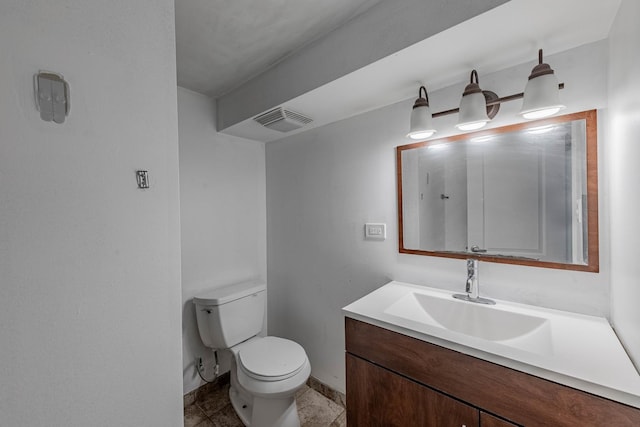 bathroom with toilet, baseboards, visible vents, and vanity