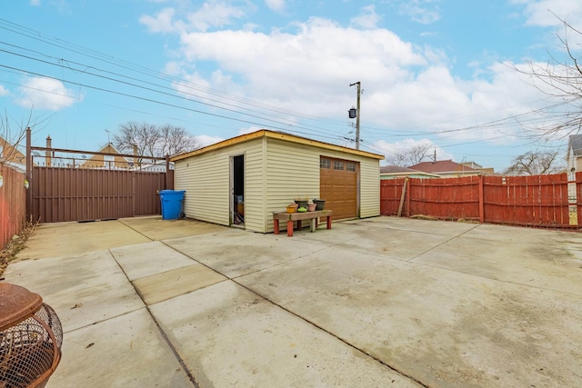 view of outdoor structure featuring an outbuilding and a fenced backyard