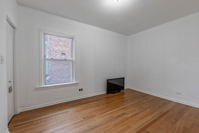 empty room with light wood-style floors and baseboards