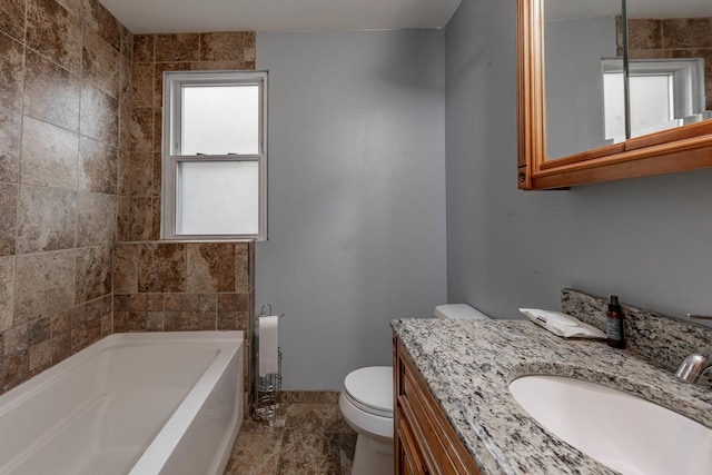 bathroom with baseboards, vanity, and toilet