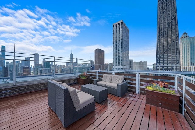 deck featuring outdoor lounge area and a city view