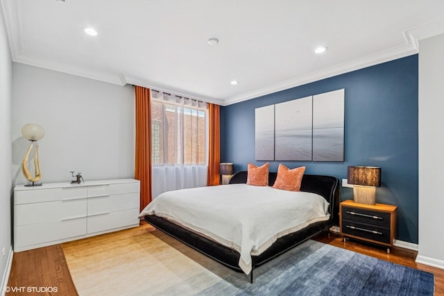 bedroom with recessed lighting, wood finished floors, baseboards, and ornamental molding