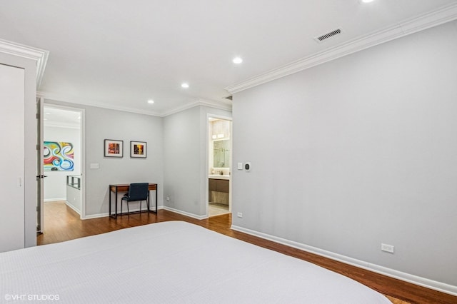 unfurnished bedroom featuring crown molding, wood finished floors, and visible vents