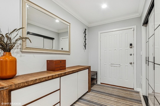 foyer with recessed lighting and ornamental molding