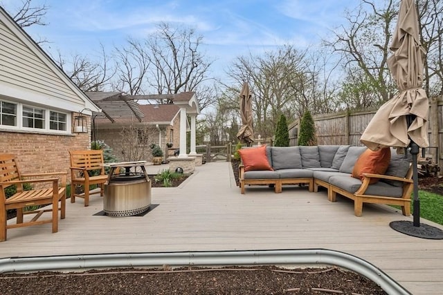 deck featuring an outdoor hangout area and fence