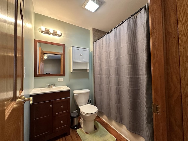 full bath with toilet, shower / bath combo with shower curtain, and vanity